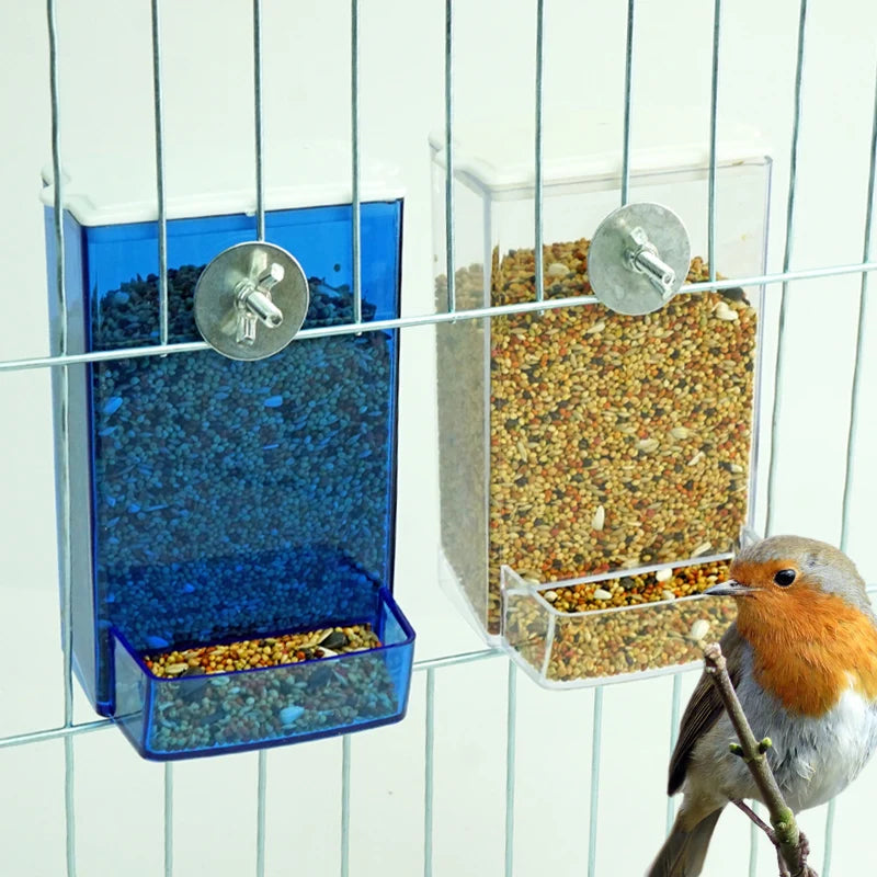 Automatic seed dispenser hanging in cage – small bird perched beside feeder